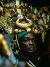 Ashanti Gold | Royal sword bearer in regalia of feathers and gold | Photo by Carol Beckwith and Angela Fisher