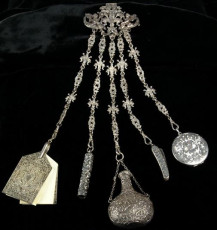 Chatelaine | C. 1985 chatelaine chatelaine with a penknife, button hook, perfume, and note cards | Image via National Park Service